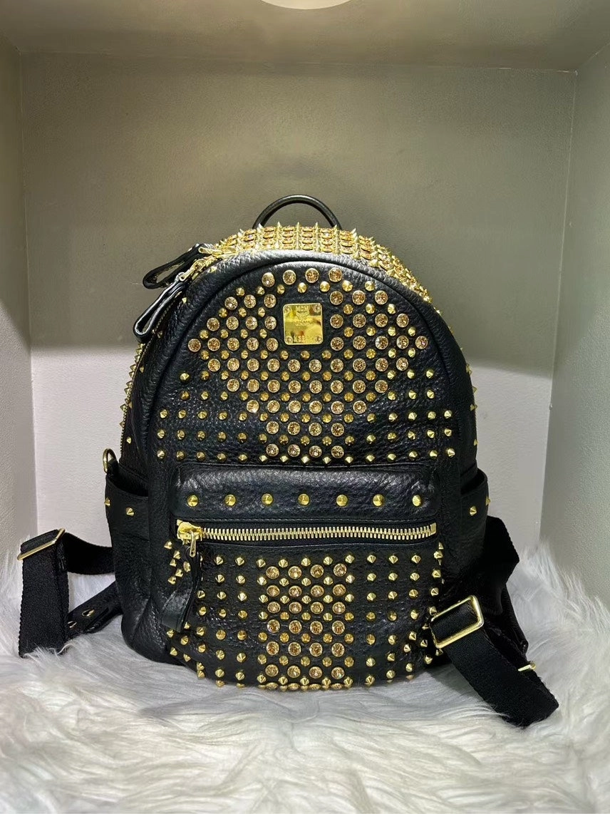 Pre-loved MCM Stark Black Backpack with Gold Studs