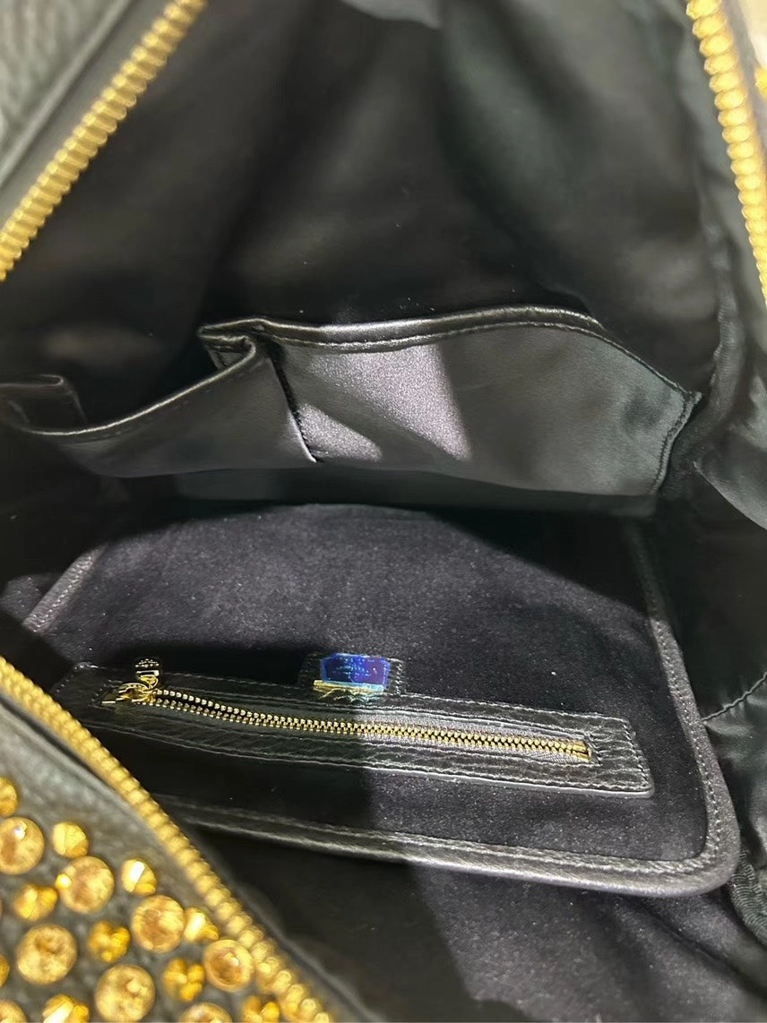 Pre-loved MCM Stark Black Backpack with Gold Studs